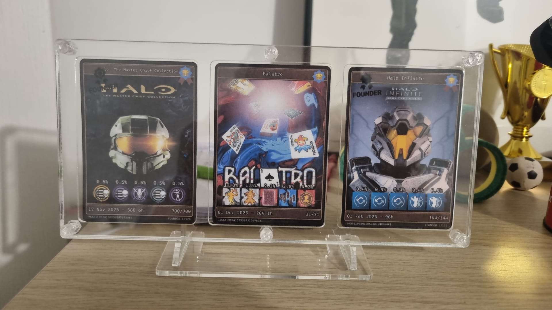 Three cards in an acrylic display frame